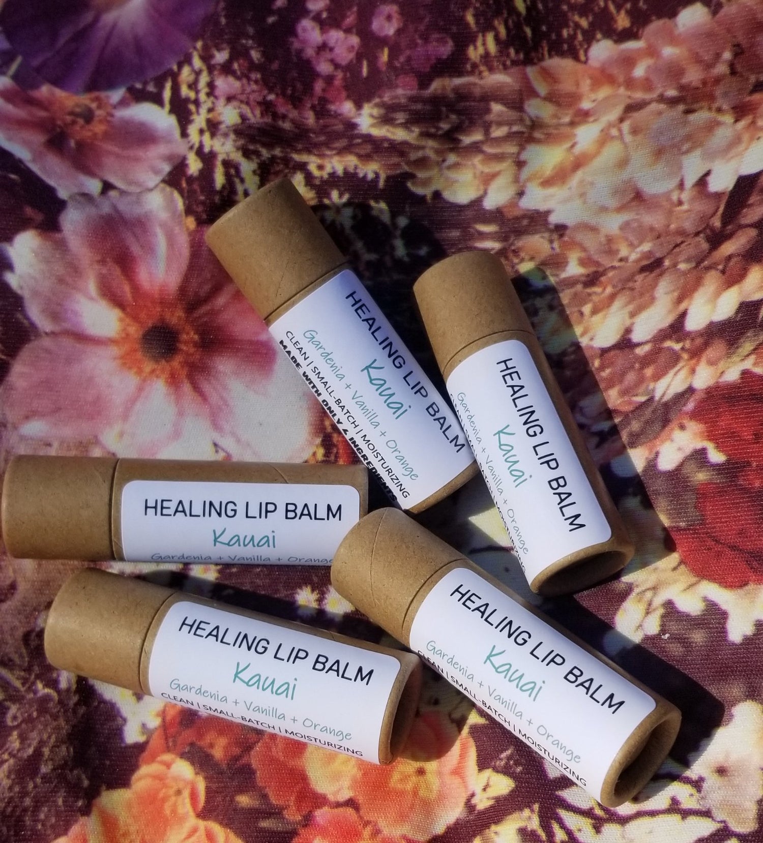 Cardboard Lip Balms with white labels, shaped in a half circle